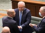 Scott Morrison and Barnaby Joyce congratulate Treasurer Josh Frydenberg after delivering the budget. Picture: Sitthixay Ditthavong