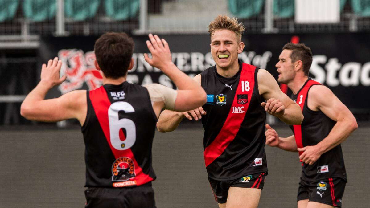 UP TOP: Will Edmunds and Ben Simpson celebrate as North Launceston trounced Glenorchy. Picture: Phillip Biggs