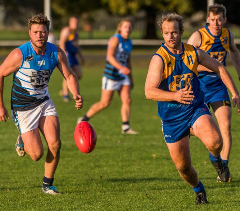 On the run: Bridport's Matthew Taylor goes head-to-head with Evandale's Justin Hutton. Picture: Phillip Biggs