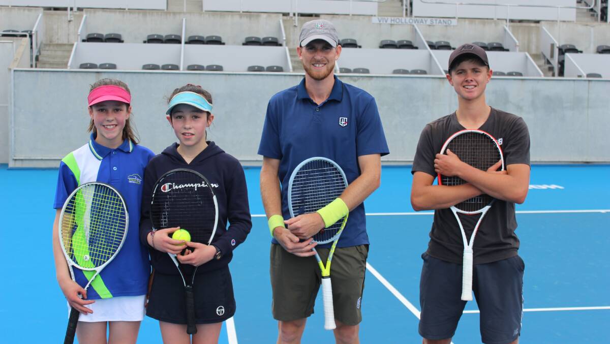 Good company: Zola Case-Boag, Escher Case-Boag and Casey Ambler (right) welcome back professional Harry Bourchier. Picture: Tennis Tasmania