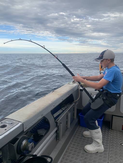 At the helm: Lachlin Hicks doing what he does best, fishing for tuna. Pictures: Supplied
