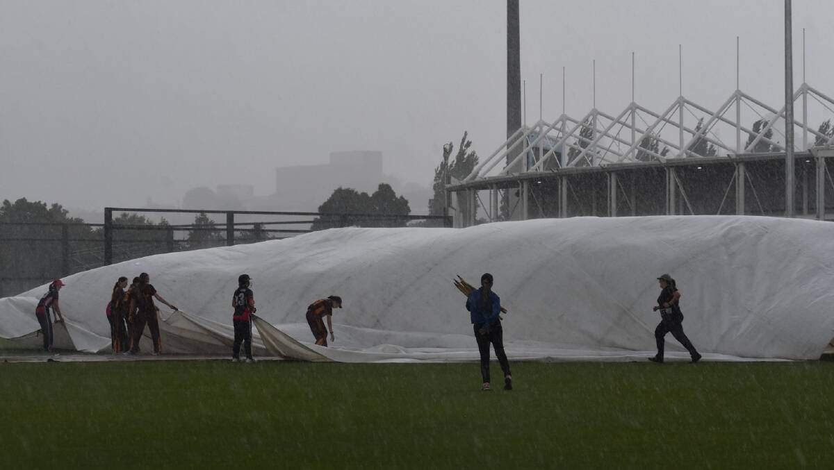 Wet and windy conditions proved a nightmare for covers application on Friday night. Picture: Kristina Partridge