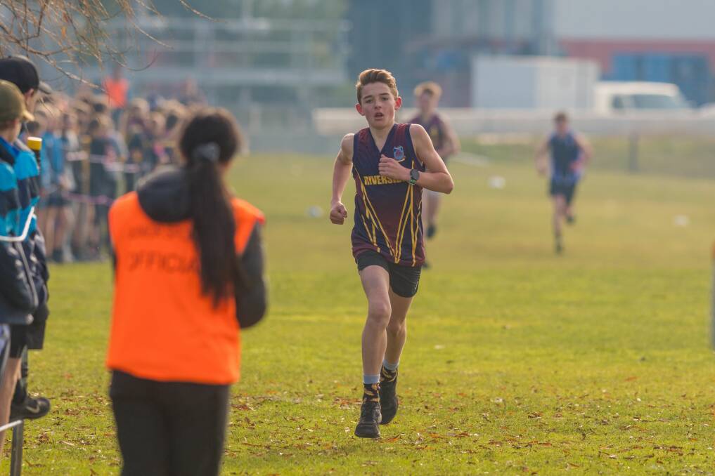 Victorious: Riverside's Aidan O'Connor is clapped towards the finish line as both he and his school pick up NHSSA wins. Pictures: Phillip Biggs.