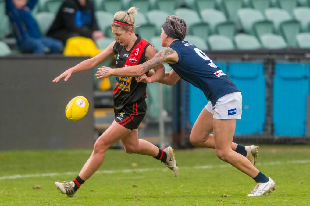 Digging in: Launceston inclusion Chanette Thuringer tackles Bombers captain Jodie Clifford. Picture: Phillip Biggs