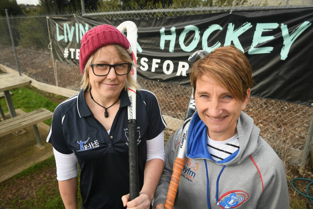Standing together: Launceston City's Emily Nunn and Queechy Penguins' Nic Duffy show solidarity for Jason Scott memorial weekend. Picture: Paul Scambler.
