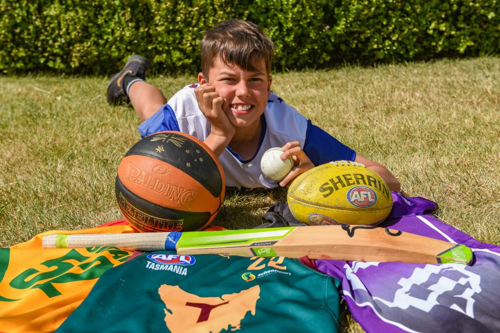 Shining star: Legana's Caleb Brewer with his team uniforms after playing basketball, football and cricket at a high level. Picture: Paul Scambler