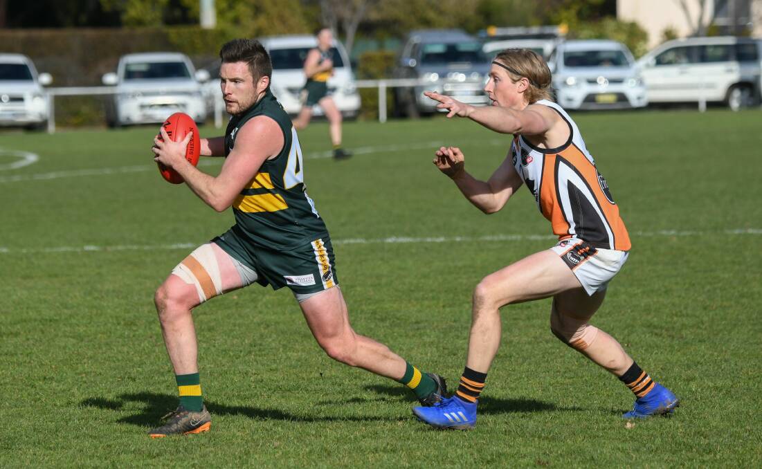 St Pats' Claye Young evades Pearce Robinson in last year's division one finals series. Picture: Paul Scambler