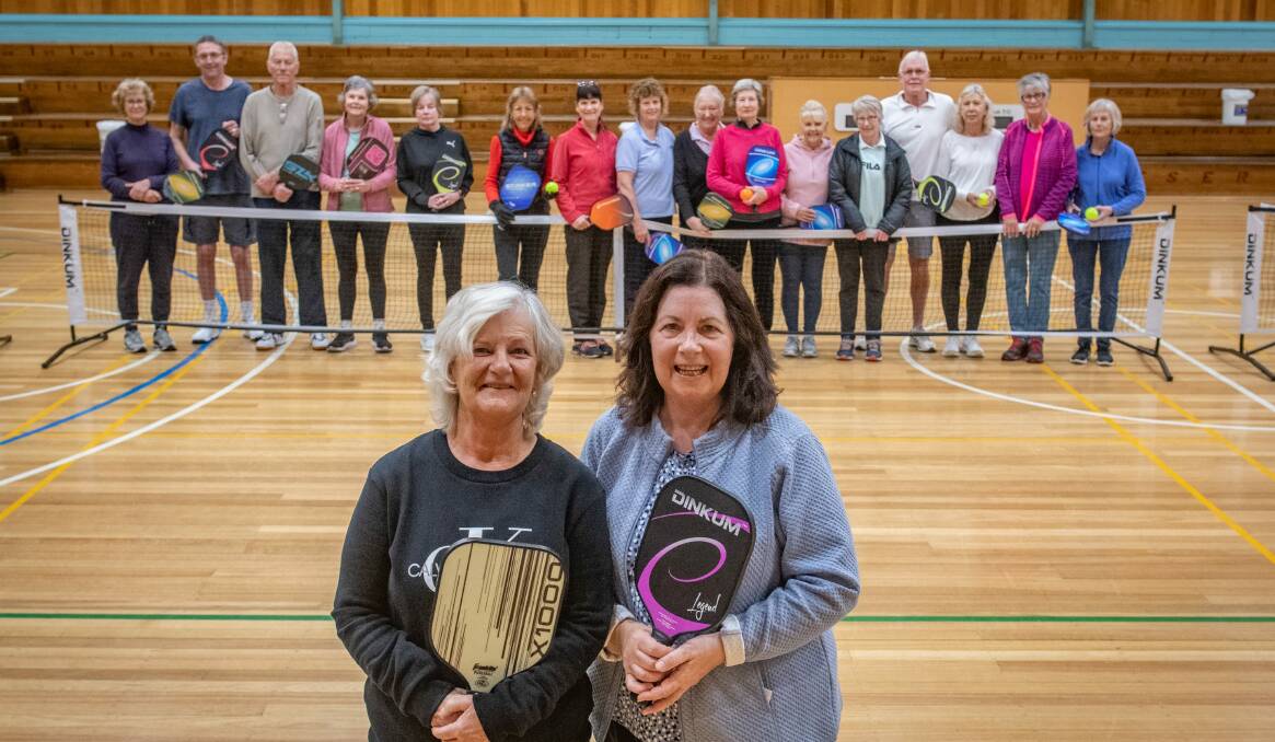 READY TO GO: Andrea O'Connor and Heather Hepburn with Launceston pickleball members. Picture: Paul Scambler