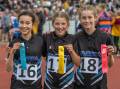 West Launceston's Sophie Rayner, East Launceston's Hanya Rush and
Summerdale's Susie Groves celebrate their 1500-metre performances.
