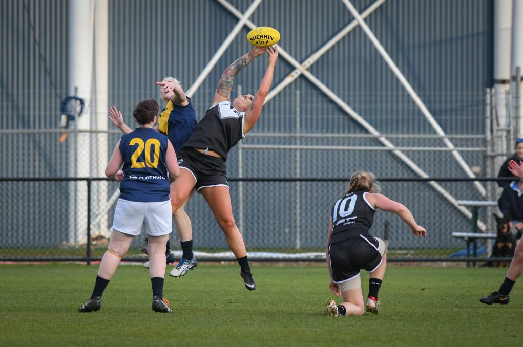 Soaring: South Launceston's Kiara Foley soars back with the flight to take a ripping mark in NTFAW's tight SFLW loss. 