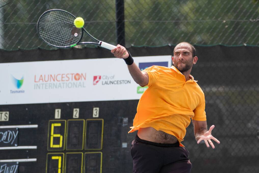 Struggle: Egyptian Mohamed Safwat hits a forehand in his contest against Liam Broady. Picture: Phillip Biggs