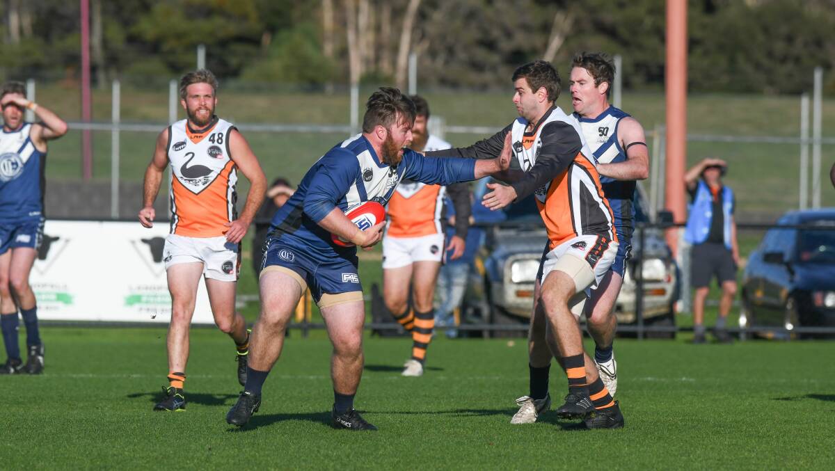 Old Launcestonian Alistair Taylor palms off his East Coast opponent in the Blues' loss last week. Picture: Paul Scambler.