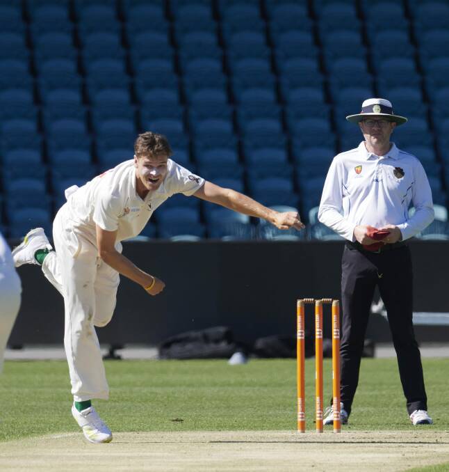 Burns watches on as North Hobart's Iain Carlisle bowls. Picture by Rod Thompson