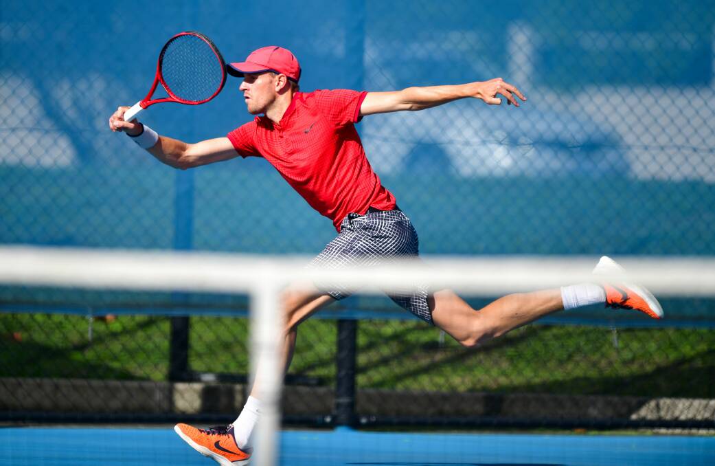 Full Stretch: Edward Bourchier lunging for a forehand at the Tasmanian Easter Championships. Pictures: Scott Gelston