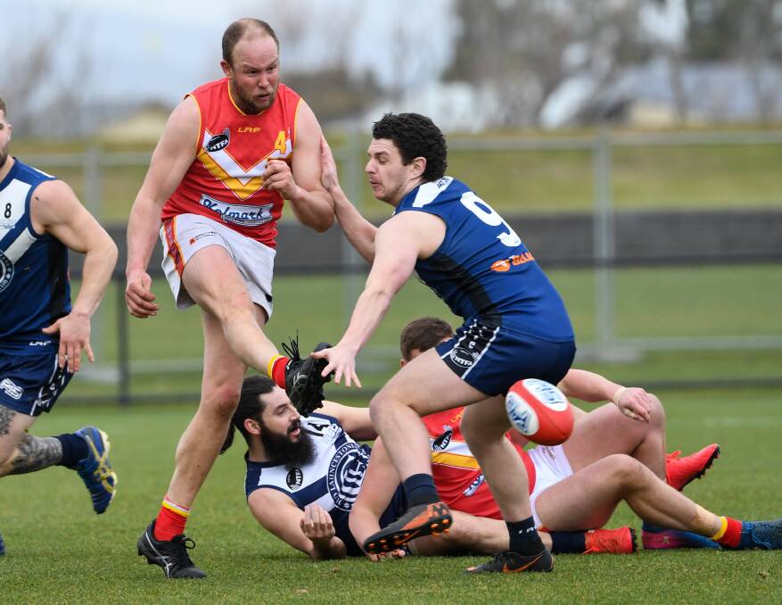 Contested: Meander Valley's Sam Archer boots forward against OLs earlier this year. Picture: Neil Richardson