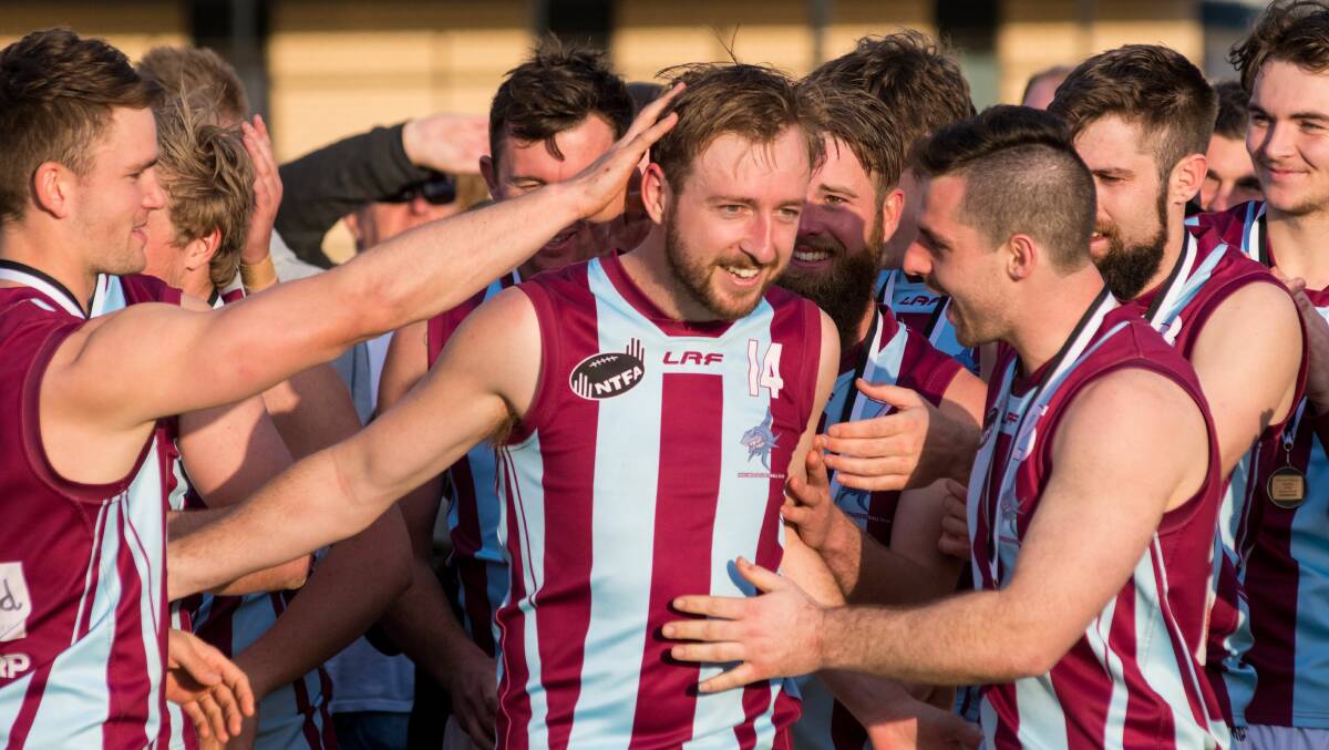 Much loved: New Deloraine recruit Damon Howe is swarmed by former Hillwood teammates after the Sharks won the 2019 NTFA premiership. Picture: Phillip Biggs
