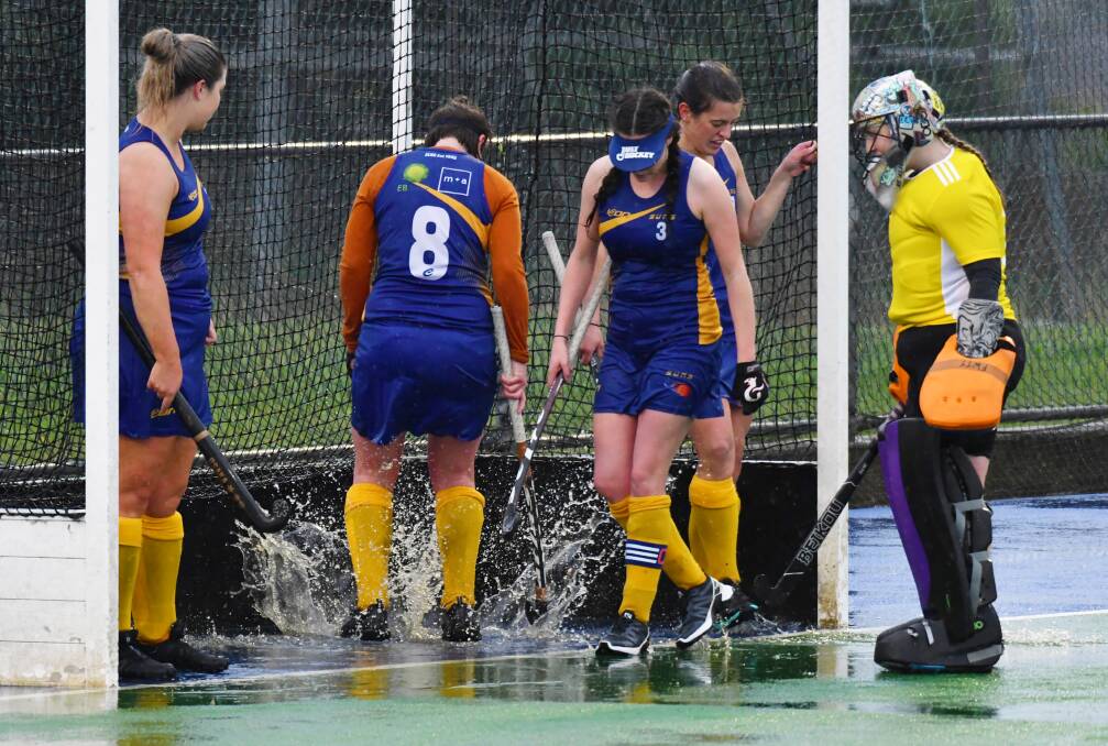 BIT DAMP: South Launceston players battle the elements. Picture: Brodie Weeding