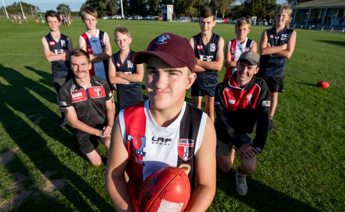 CLOSE: George Town's Hayden Simmons with coaches Alec Daniels and Lachie Mason, teammates and Launceston opponents. Pictures: Phillip Biggs