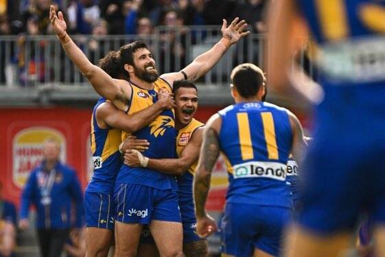 He'll kick them: West Coast's Josh Kennedy is swarmed by teammates after doing what he did best, kick goals. Pictures: Twitter