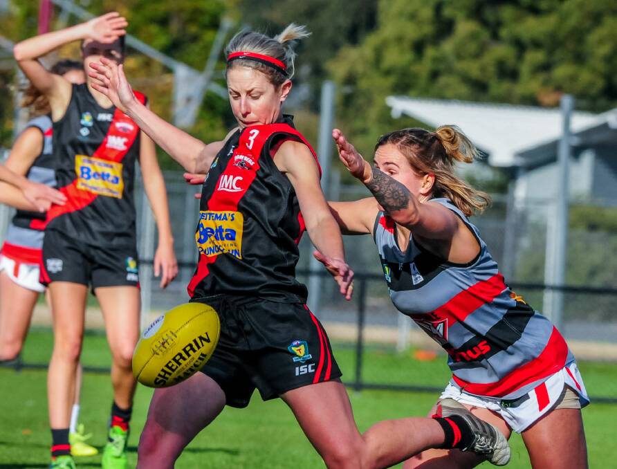 Evade: Jodie Clifford gets passed her outstretched opponent and progresses play for North Launceston.