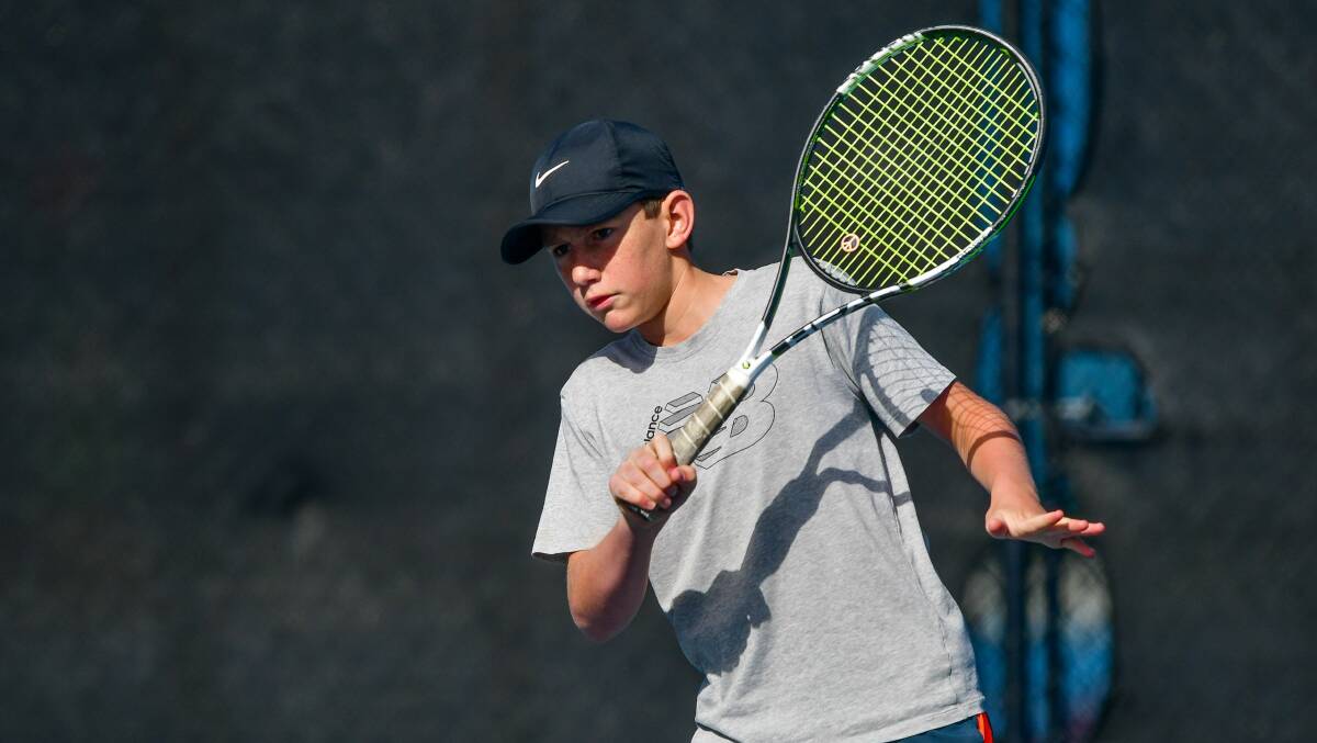 Composed: Launceston's Fletcher Young focuses on his forehand in his second round under-14s clash against New South Wales' Nathan Porley.
