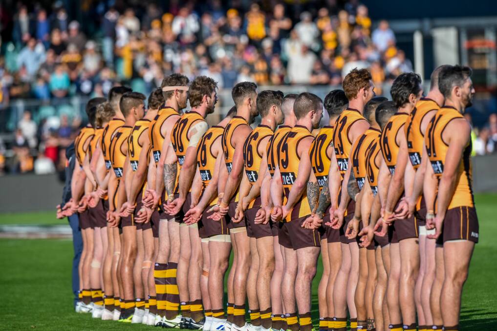 Honour: Hawthorn players form a line to pay respects to the Anzac heroes who paid the ultimate sacrifice. 