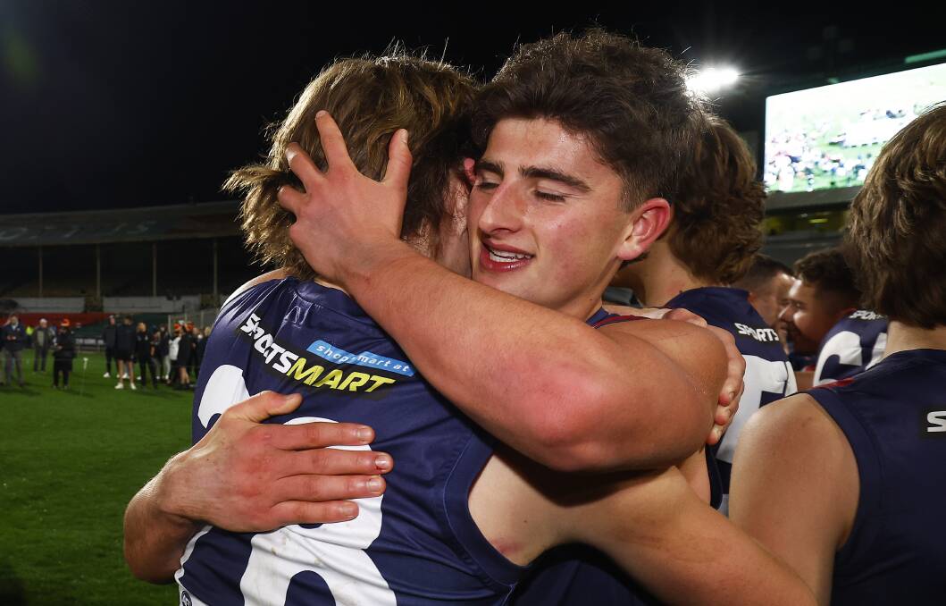 North Launceston's Ryley Sanders [left] and North Melbourne's Harry Sheezel embrace after last year's NAB League premiership win. Picture by Getty Images