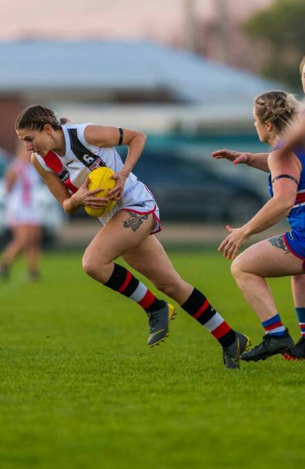 Quick feet: Jayde Barrenger, who has impressed coach Dave Marshall so far this season, uses her speed to evade a South Launceston opponent. Picture: Phillip Biggs