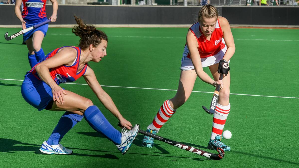 Sarah McRobbie attempts to stop Jess Abey in her tracks. Picture: Neil Richardson.