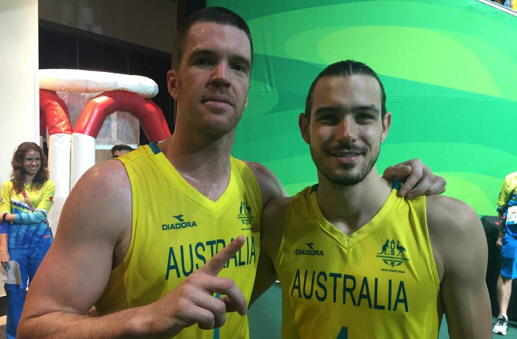 Golden guys: Lucas Walker (left), pictured with fellow Tasmanian Chris Goulding, has announced his basketball retirement.