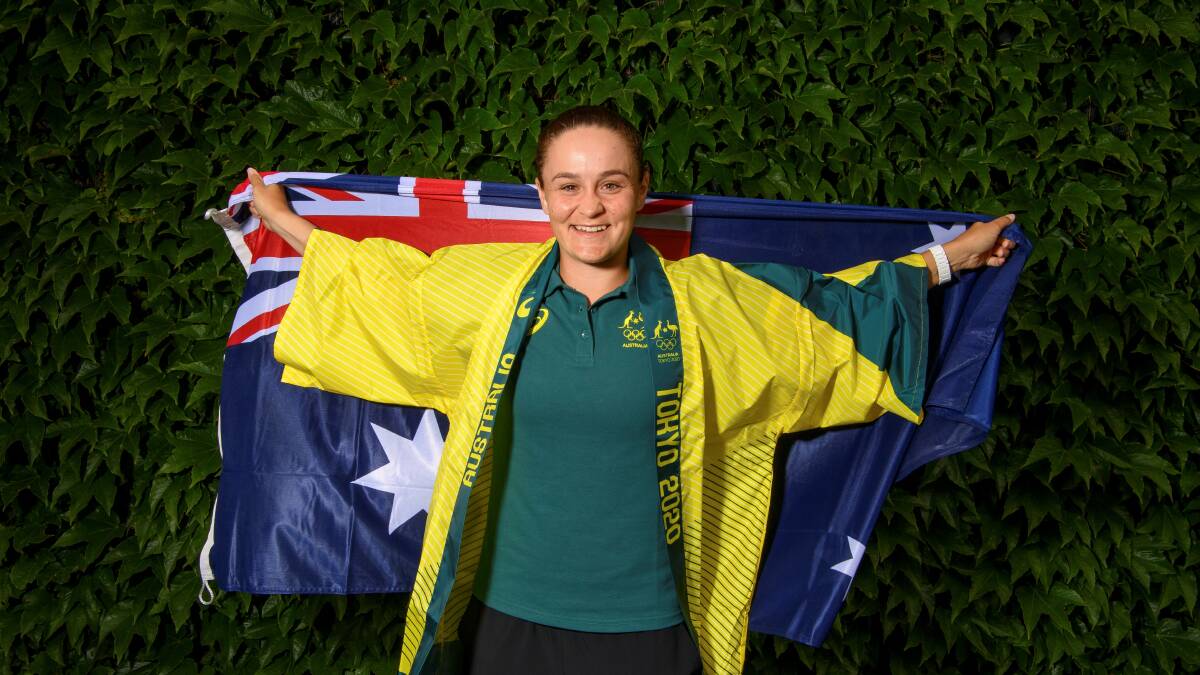 AUSSIE ASH: Ash Barty holds the Australian flag high and proud in preparation for the Tokyo Olympics after winning Wimbledon. Picture: AOC