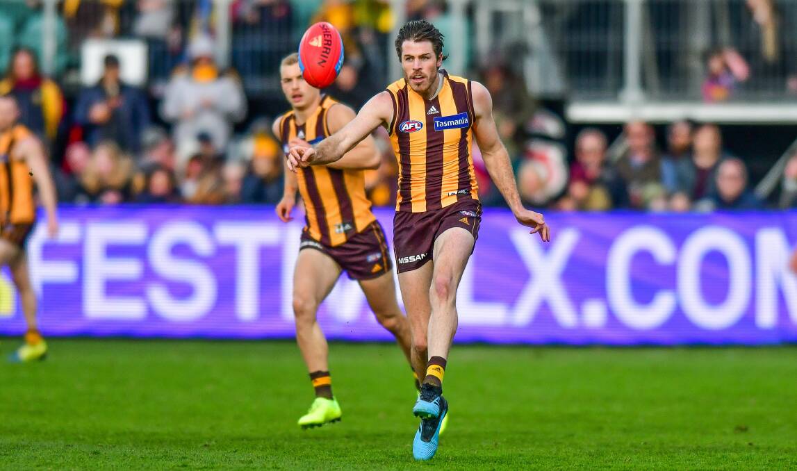 Moving forward: Hawthorn leader Isaac Smith kicks towards a teammate in last year's Brisbane Lions clash. Picture: Scott Gelston