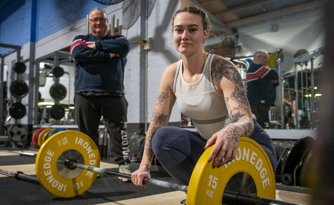 Watchful eye: Tasmanian Olympian Ron Laycock looks over the shoulder of up-and-coming weightlifter Angie Arnold. Picture: Paul Scambler 