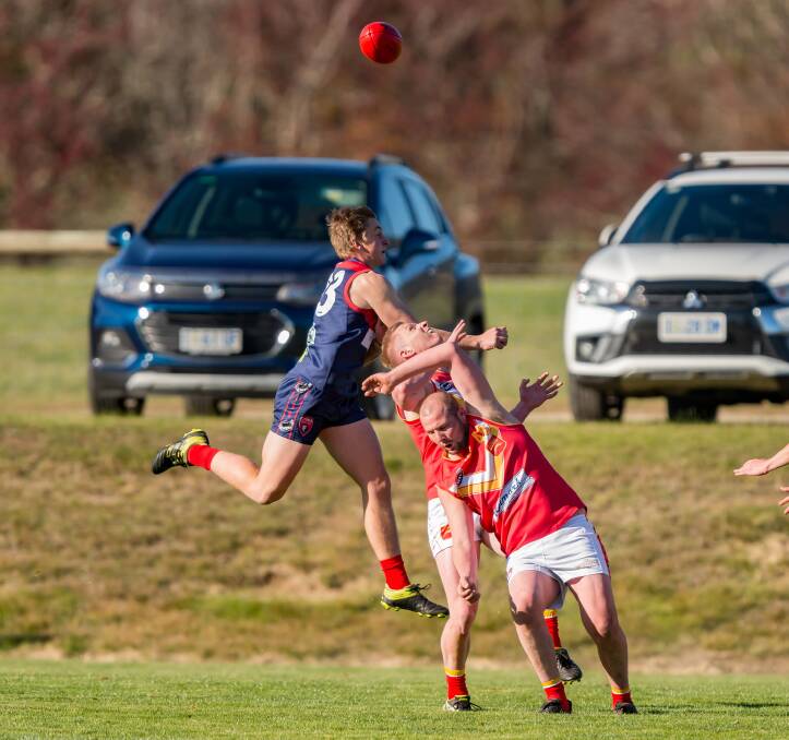 Lilydale's Sam Lockett crashes a pack with the football up high.