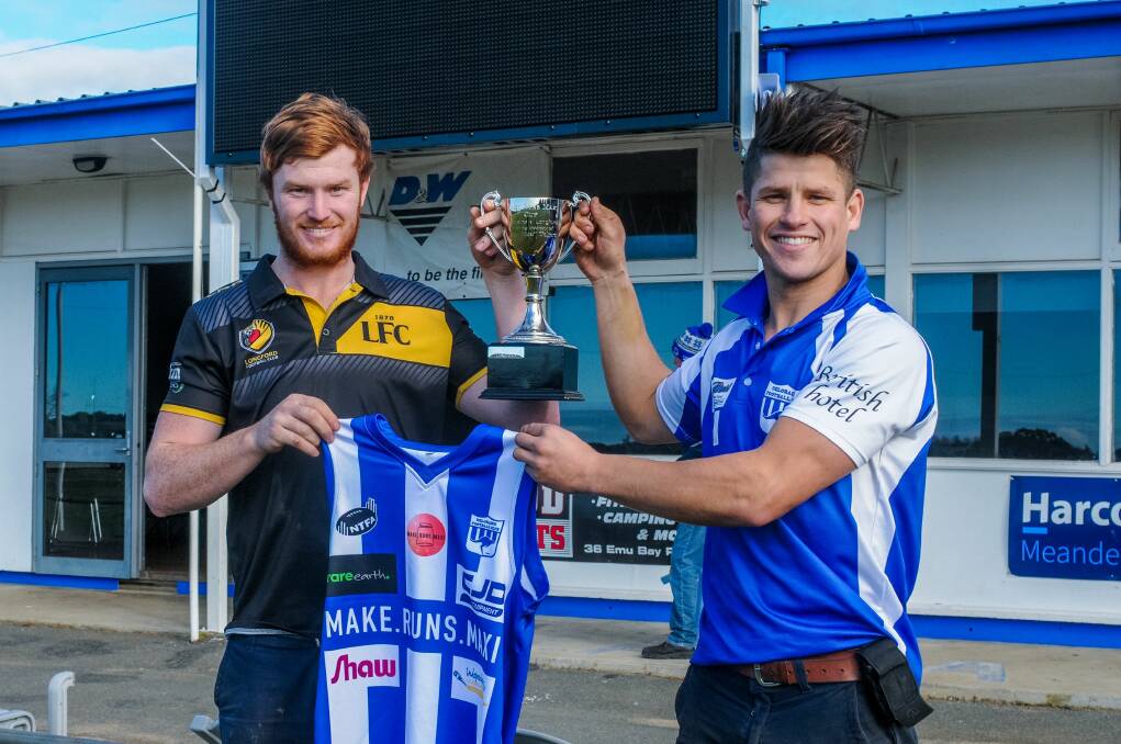 Together: Longford's Jackson Blair and Deloraine's Lochy Dornauf hold the Make Runs Maxi cup and Deloraine's guernsey. Picture: Neil Richardson.