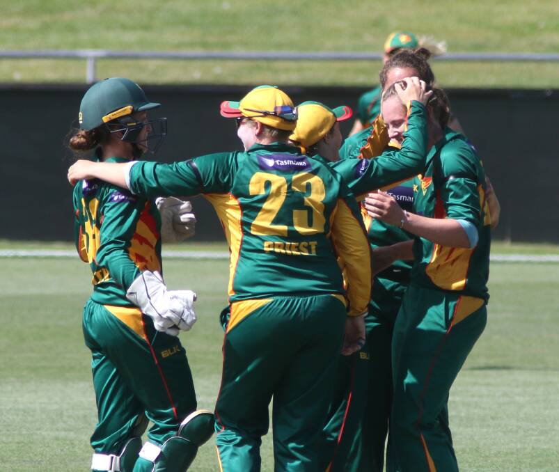 Get around her: Rachel Priest celebrates with the Tigers after Sam Bates took the prized wicket of Meg Lanning. Picture: Rick Smith