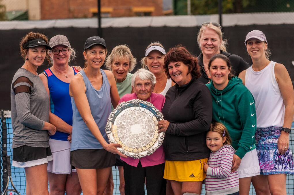 Going for gold: Midweek ladies finalists Riverside and AIC/Longford pose with the trophy and tennis legend Joan Carswell. Picture: Phillip Biggs 