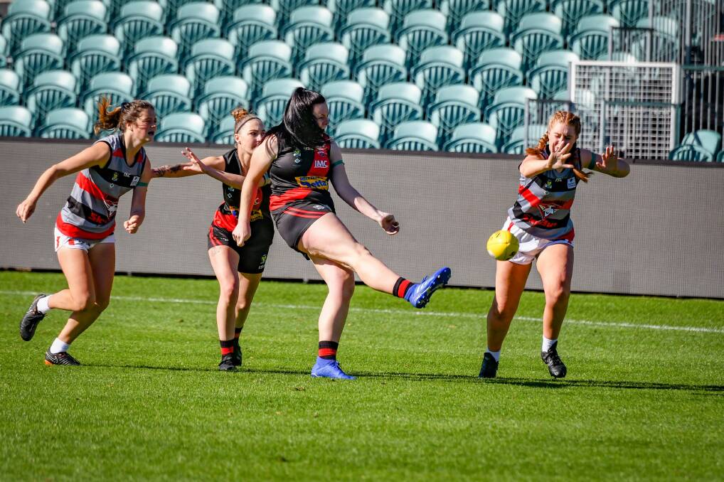 Homeward bound: North Launceston's Emily McKinnell snaps for goal in round two's Bombers derby. Picture: Paul Scambler.