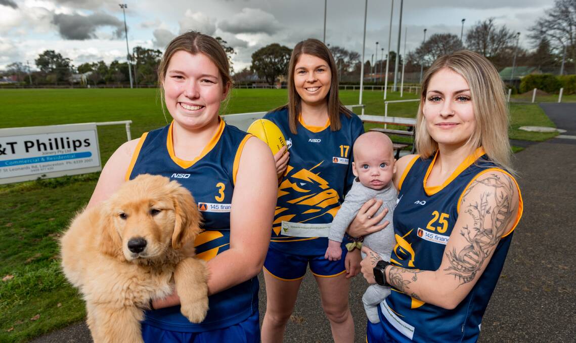 What a crew: Charlotte Layton with dog Whisky, Jackie Harvey and Ebony Vocke with son Vincent. Picture: Phillip Biggs