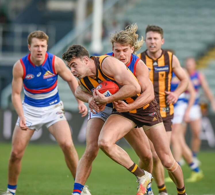 Wrapped up: Hawthorn's Conor Nash is tackled by Western Bulldogs' Bailey Smith last year at UTAS Stadium. Picture: Craig George