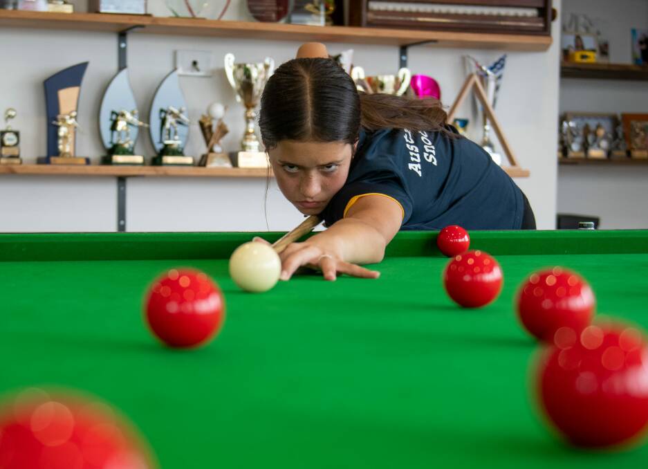FOCUSED: Lilly Meldrum practises on her family's home snooker table. Picture: Paul Scambler