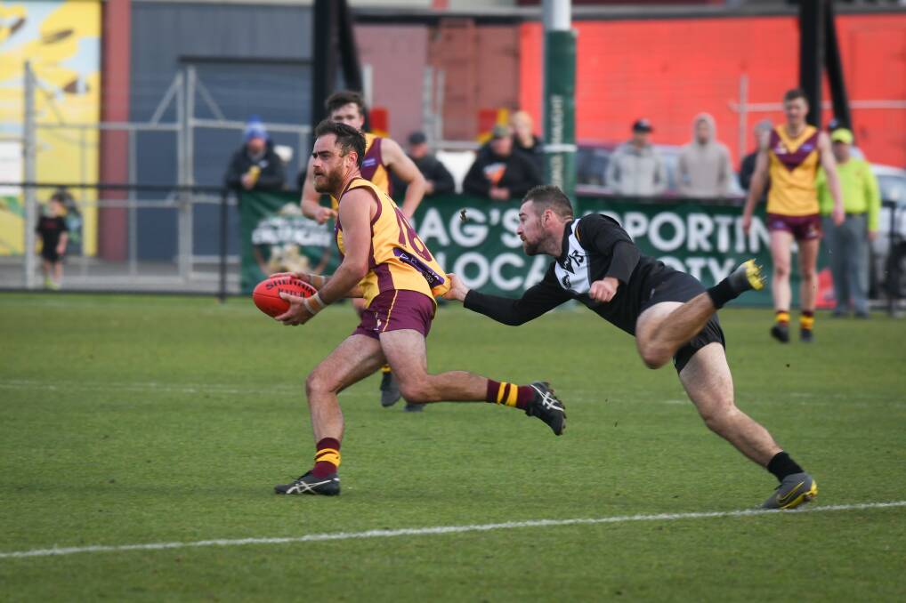Out of reach: NWFL's Chris McDonald is too quick for Luke Richards as the North West side prevail by 34 points in the representative game. Picture: Paul Scambler