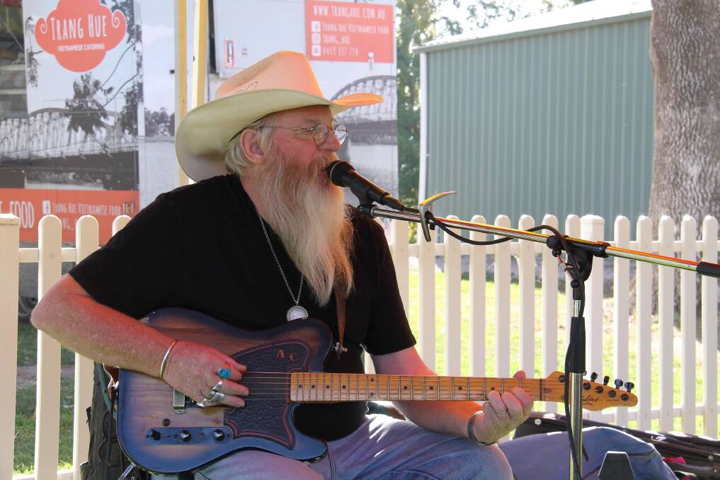 Strumming a country classic entertainer Allan Caswell.