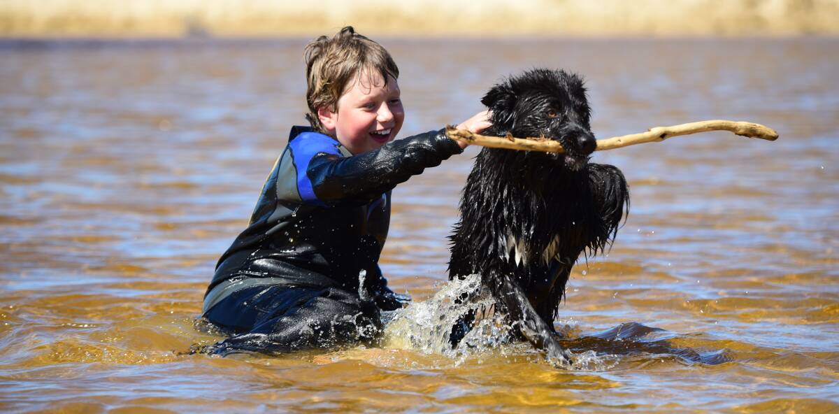 FUN IN THE SUN: Briely Martin-Shepherd, 10, of Launceston, plays with Maggie in the water at Scamander. Picture: Paul Scambler.