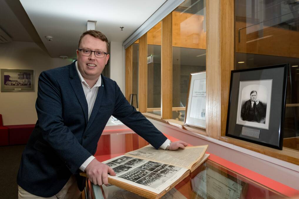 HISTORY: Editor Corey Martin with one of the early editions of The Examiner. Picture: Phillip Biggs