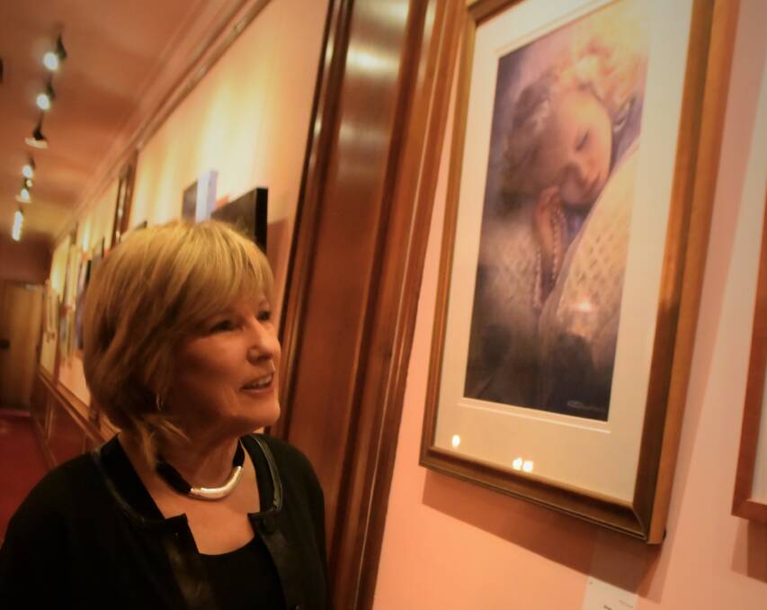 ARTISTIC: Launceston Art Society president Carolyn Riley admires the works in the Meandering exhibition, on show at the Country Club. Picture: Piia Wirsu