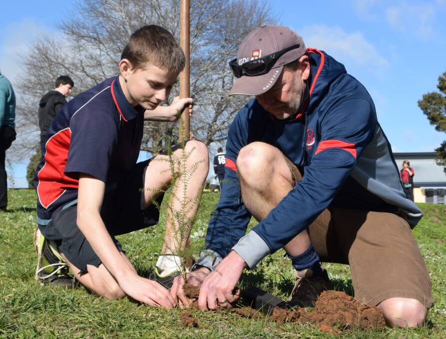 GREEN THUMBS: Jason Maney and Tony Harrington planting trees at Queechy High for National Schools Tree Day on Friday. Picture: Piia Wirsu