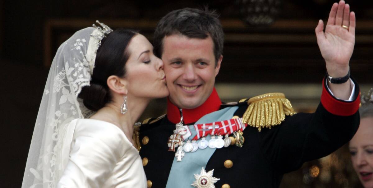 LOVE: Crown Princess Mary kissed Crown Prince Frederik as the Royal couple appear on the balcony of Christian VII's Palace after their wedding on May 14, 2004.