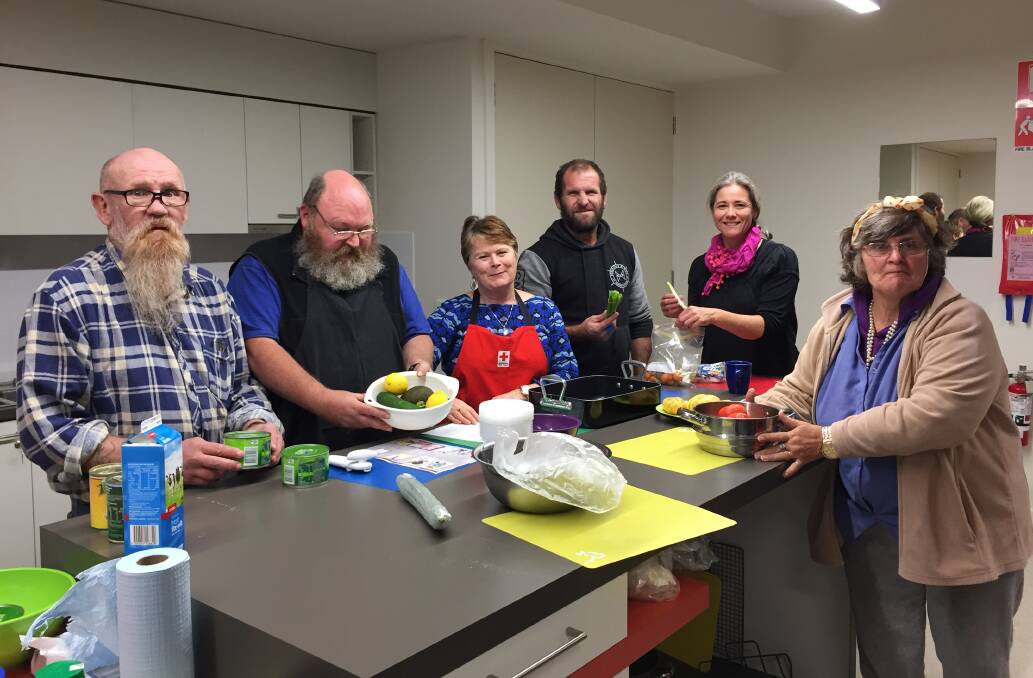 KEEN KITCHEN: Barry Greaves, David Cooke, Siobhan Reid, Terry Thow, Mary Rummery and Jennie Ronan preparing to cook a meal. Picture: Holly Monery