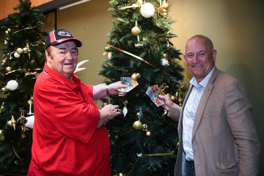 FINAL DONATION: Moonbeam Children's Committee chairman Peter Doddy and treasurer Hugh Mckenzie donating $2000 from the final pool of charity cash to The Examiner's 109th Empty Stocking Appeal. Picture Neil Richardson